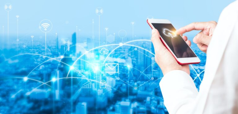 Man's hand using smartphone to connecting data information and blurred city background