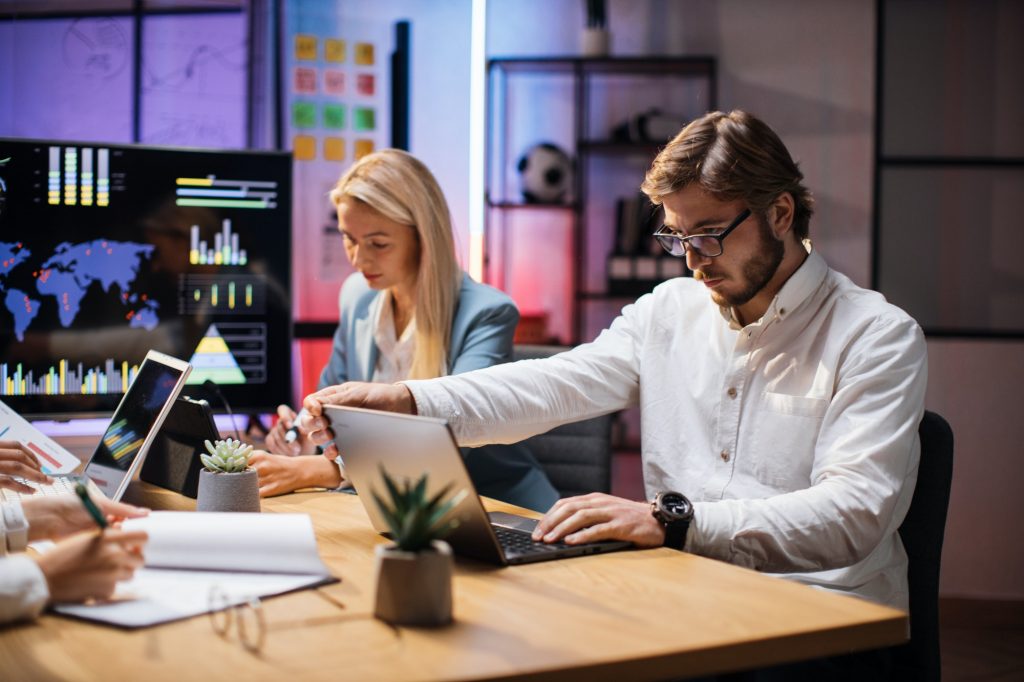 Caucasian business people monitoring trade market on gadgets