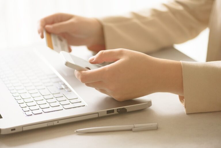 Hands holding credit card and smatrphone. Onine shopping. Business, remote work, always connect