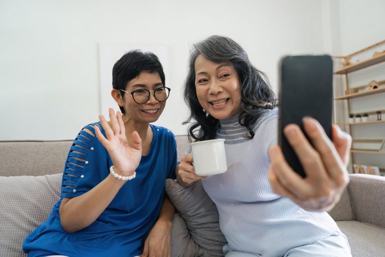 Elderly women, phone social media and living room with senior females with mobile connectivity