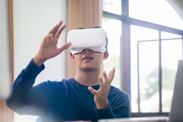 Young asian man using virtual reality glasses