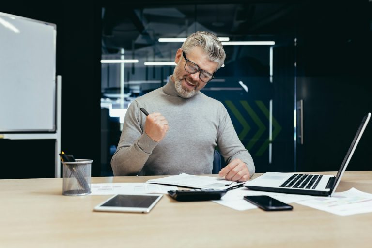 A senior business man in the office and signing a successful contract. making a profitable deal