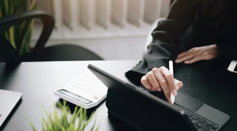 businesswoman use a digital tablet to check financial data.