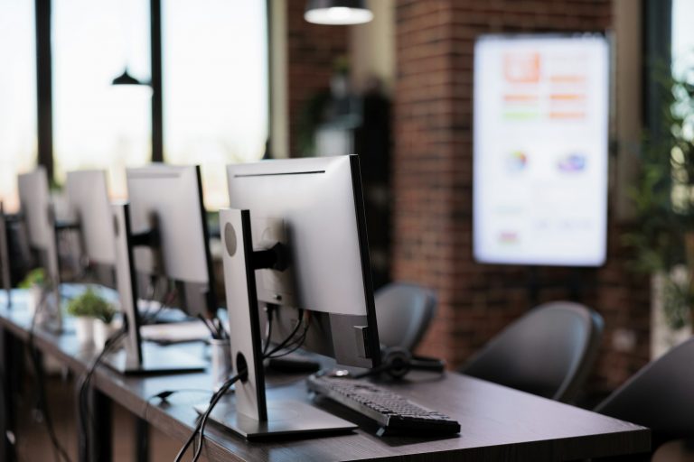 Nobody in office with multiple monitors at customer service desk