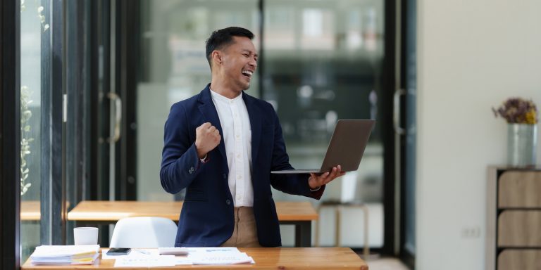 A successful entrepreneur analyzing a technical price graph and indicator with laptop computer